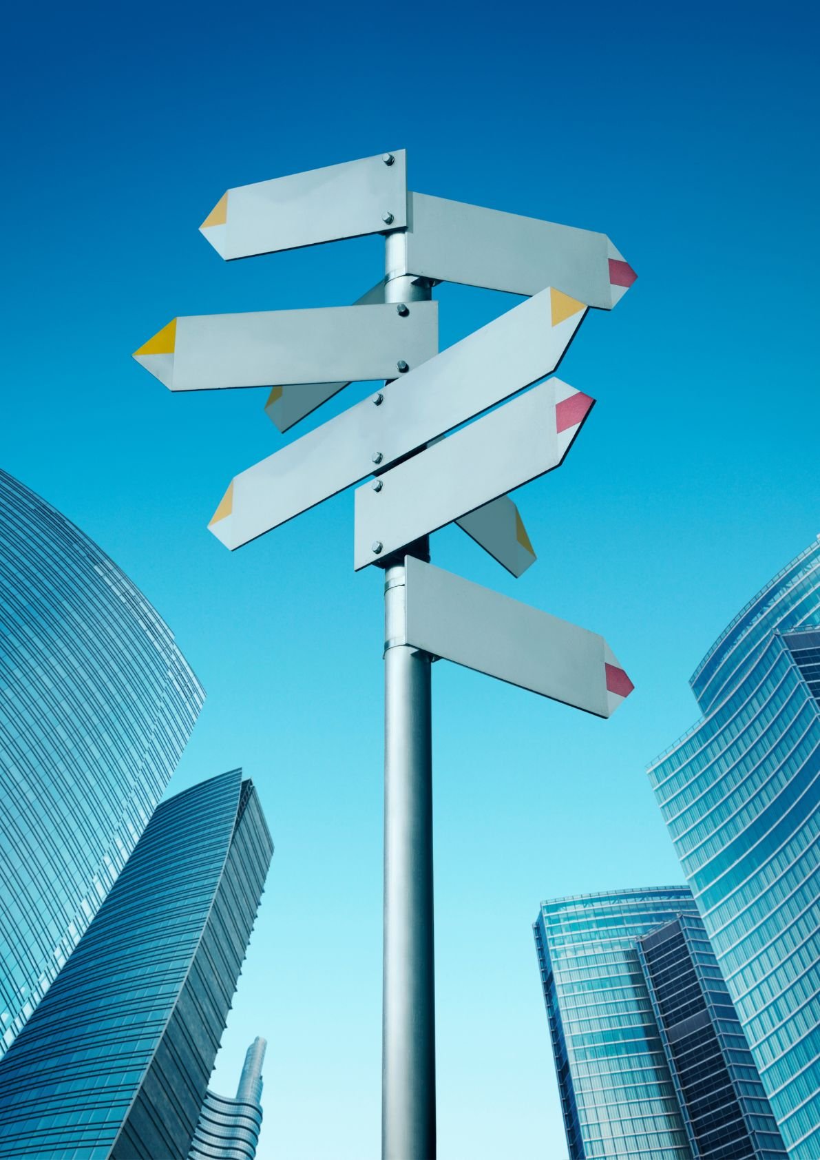 Directional signpost with multiple pathways in business district representing 5 proven pathways